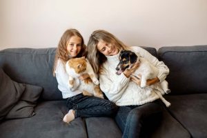 a person hanging out with their dog on the couch